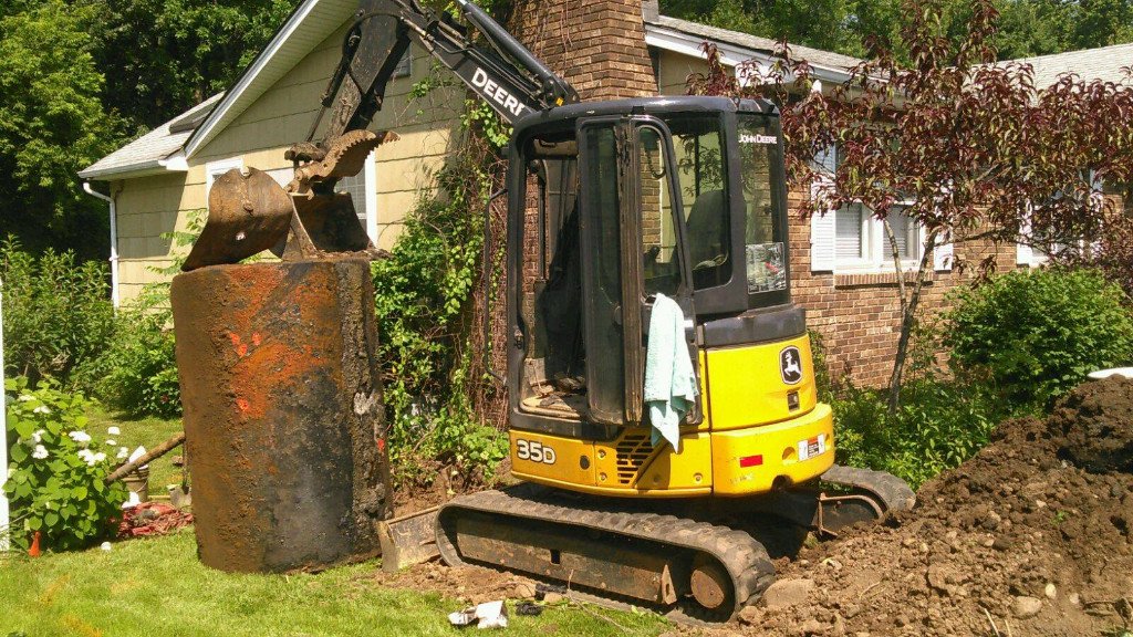 Oil tank removal crew excavating a buried oil tank in Suffolk County NY