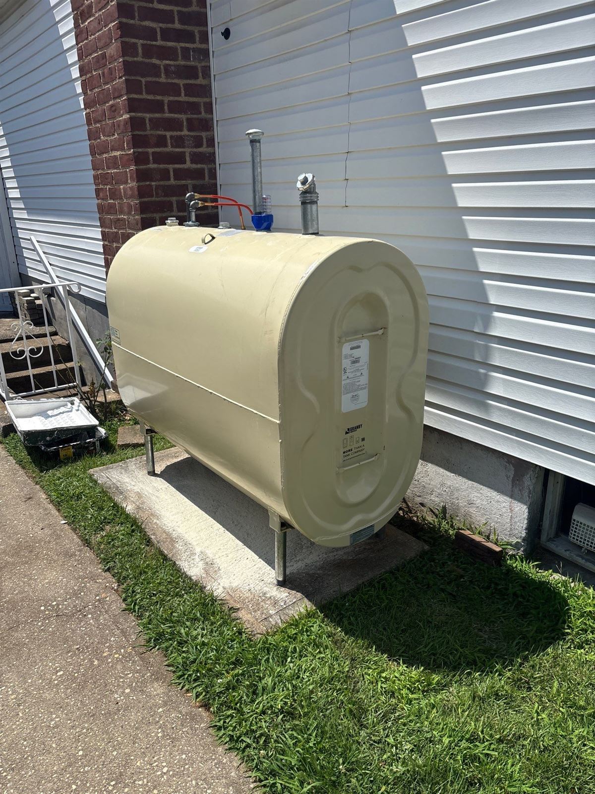 New Granby oil tank installed on a concrete pad outside a home