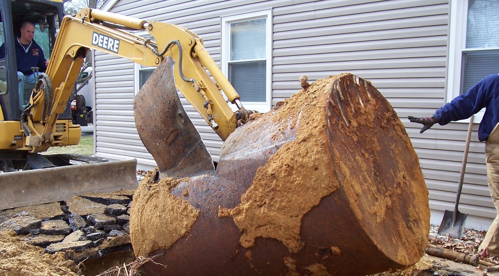 Excavator removing a buried oil tank in Suffolk County, Long Island
